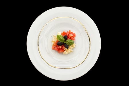 Delicious caprese tartar in glass plate on a black background.の写真素材