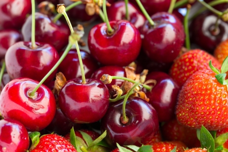 Closeup of red fresh ripe strawberries and cherry.の写真素材