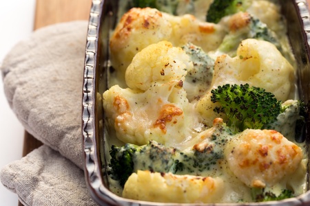 Gratin of cauliflower, broccoli and cheese in brown rustic dish.の写真素材