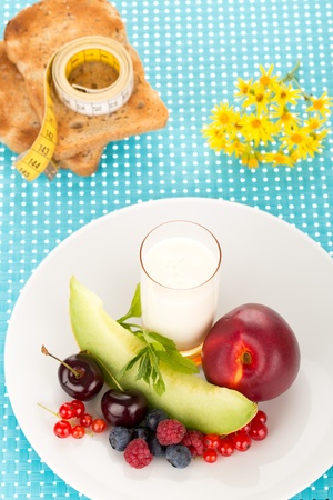 Healthy breakfast with a plate of fresh fruits, glass of milk.の写真素材