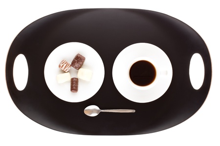 Chocolate assortment in white plate and cup of coffee.の写真素材