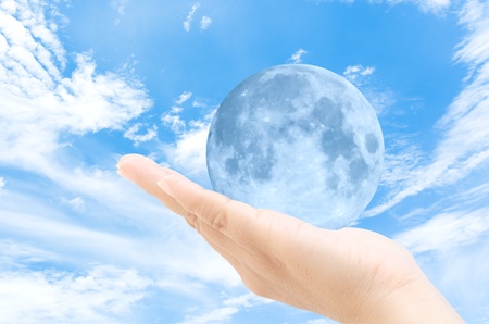 moon in the woman hands with sky backgroundの写真素材