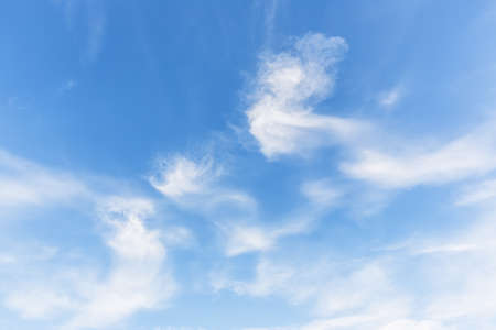 white fluffy clouds in the blue skyの写真素材