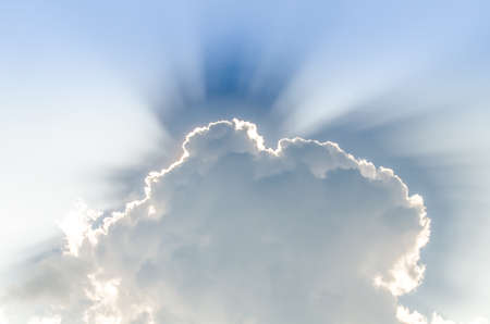 Sunbeam through the haze on blue sky: can be used as background and dramatic lookの写真素材