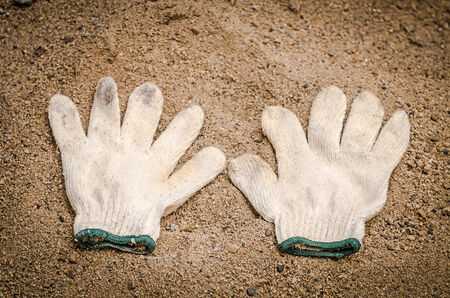 gloves worn embedded in the sandの写真素材