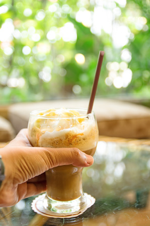 hands holding coffee, hands holding a glass of coffeeの写真素材
