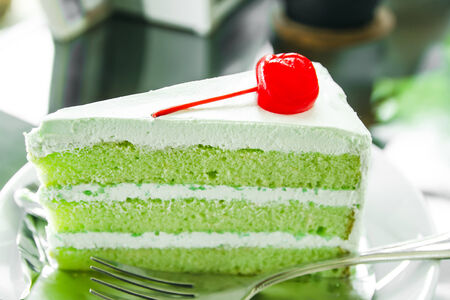 Piece of pandan cake and cherry, Pandan cakeの写真素材