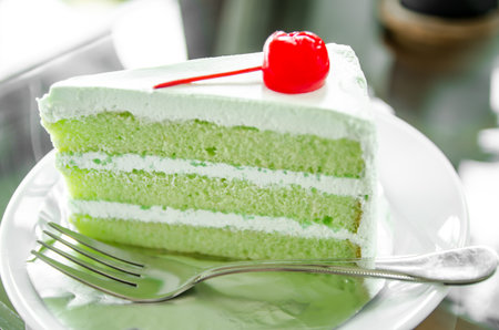 Piece of pandan cake and cherry, Pandan cakeの写真素材