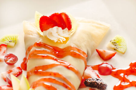 Crepes with cream and strawberries の写真素材