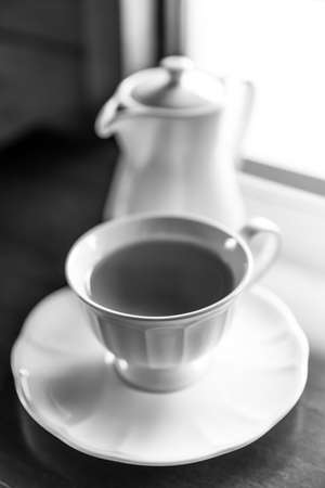Cup of tea and teapot on wooden table closeupの写真素材
