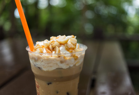 Closeup image of ice coffee with whipped cream and macadamia nutsの写真素材