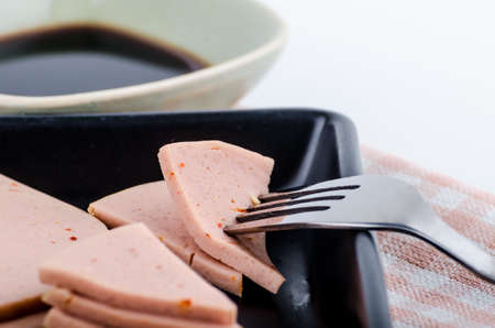 vegetarian  bolognese sausages isolated on plate with forkの写真素材