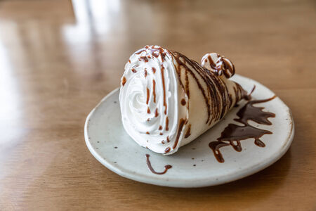 Rolled thin pancakes with sweet creamの写真素材