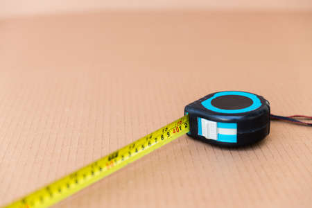 Steel tape measure tool isolated on brown carton paper backgroundの写真素材