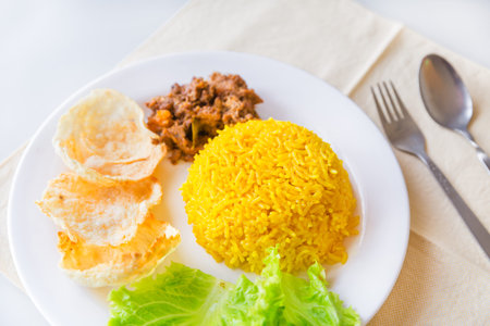 turmeric rice with vegetables and vegetarian rendang, Indonesian foodの写真素材