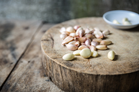 garlic cloves on a wooden cutting boardの写真素材
