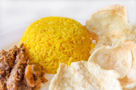 turmeric rice with vegetarian rendang and krupuk, Indonesian foodの写真素材