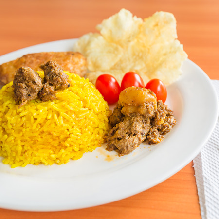 turmeric rice with vegetarian rendang and krupukの写真素材