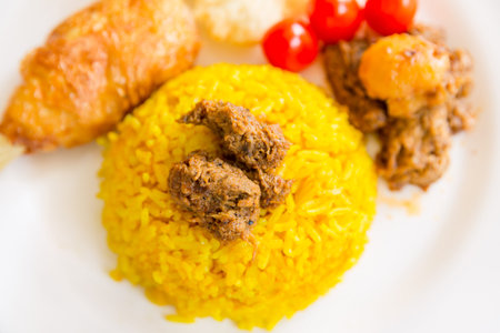 turmeric rice with vegetarian rendangの写真素材