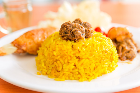 turmeric rice with vegetarian rendangの写真素材