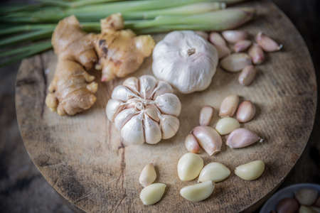 Still-life with garlic on wood cutting boardの写真素材