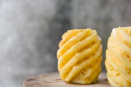 peeled pineapple on a wooden backgroundの写真素材