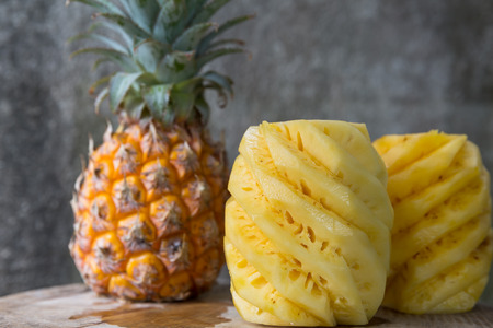 Pineapple, peeled pineapple on a wooden backgroundの写真素材