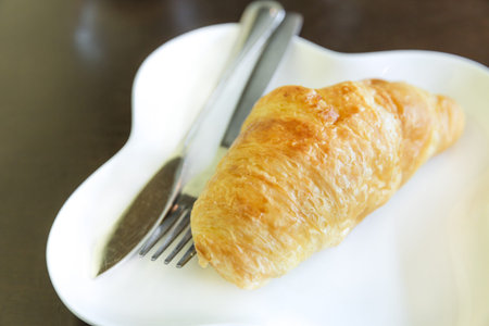Freshly baked french butter croissants on plate, breakfast with fresh croissantの写真素材
