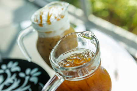 A jug of ice coffee topping with cream, Iced coffee in jugの写真素材