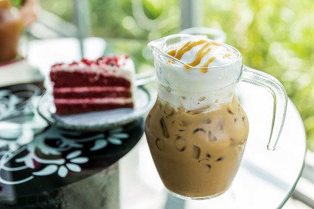 A jug of ice coffee topping with cream, Iced coffee in jugの写真素材