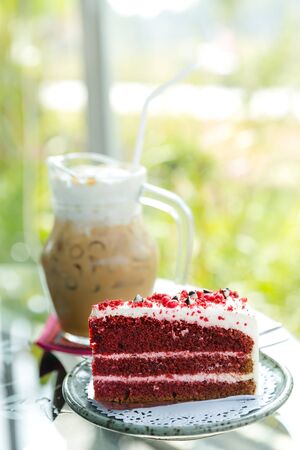 one slice of red velvet cake in front of the whole dessert, red velvet cakeの写真素材