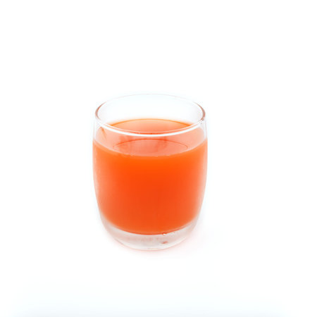 Fresh carrot juice glass on white backgroundの写真素材