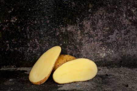 Sliced potato tubers in a basket, cut in half potato-still lifeの写真素材