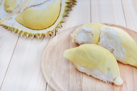 Durian in wooden plate on wood tableの写真素材