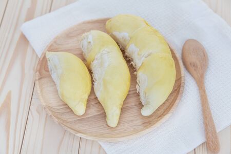 Durian in wooden plate on wood tableの写真素材
