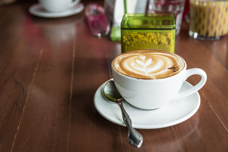 cup of cappuccino, cup of coffee, cup of coffee on brown wooden tableの写真素材