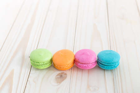 Sweet colorful macaroons on a wood backgroundの写真素材
