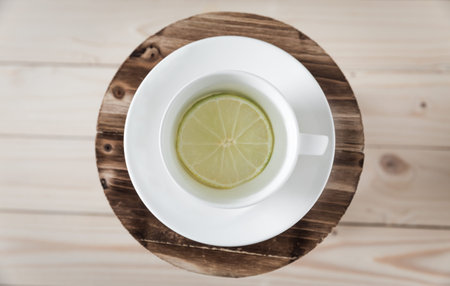 Fresh water with lemon in glass on wooden background-top viewの写真素材