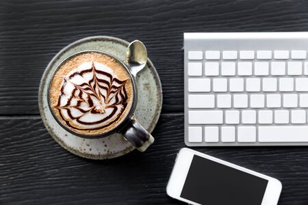 Office desk table with computer and coffee cup, Close up over head viewの写真素材