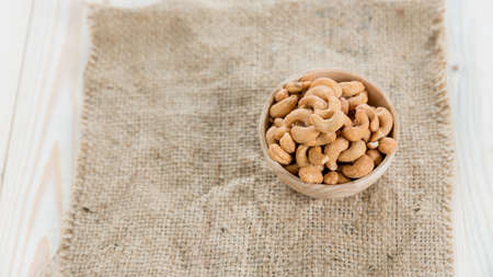 cashew nuts in a wooden bowlの写真素材