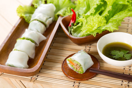 Portion of spring rolls with spicy sauce, vegetables in noodle tubeの写真素材