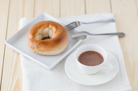Mug of hot chocolate or cocoa with toasted bagel