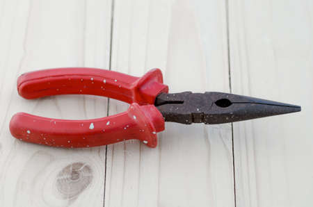 Pliers tools for electrician on wooden background, A pair of rusty needle nosed pliersの写真素材