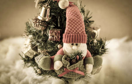 Santa Claus puppet on Christmas tree, Santa Claus against a Christmas tree:vintage styleの写真素材