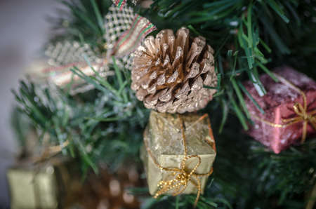Golden pine cone on christmas tree, christmas treeの写真素材