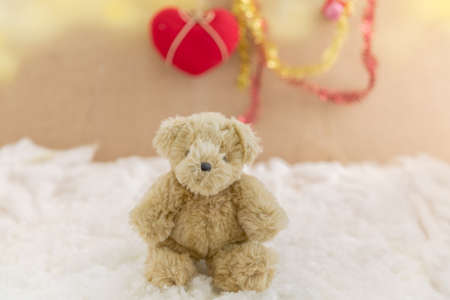 Teddy bear is sitting on snow background-concept christmas and new yearの写真素材