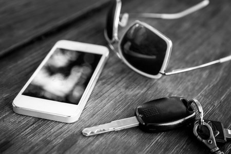 car key with smartphone and sunglasses - black and whiteの写真素材