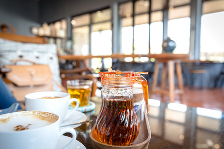 a jug of syrup, brown clear syrup in a small jug for coffee