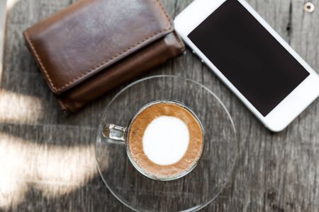 Espresso Coffee, Lie on wooden floor smartphone, coffee and wallet-coffee cup on table and mobile phone,walletの写真素材