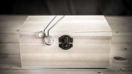 wooden box with rings, ring on wooden box resting on a wooden table-vintage styleの写真素材